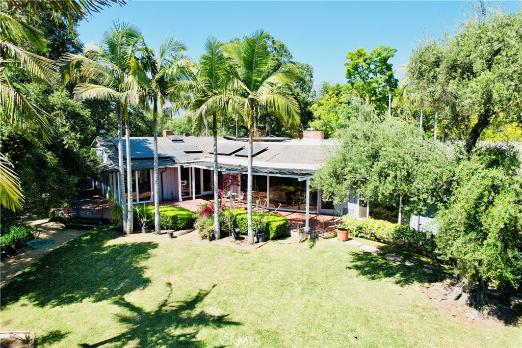 a view of a house with a backyard and a patio