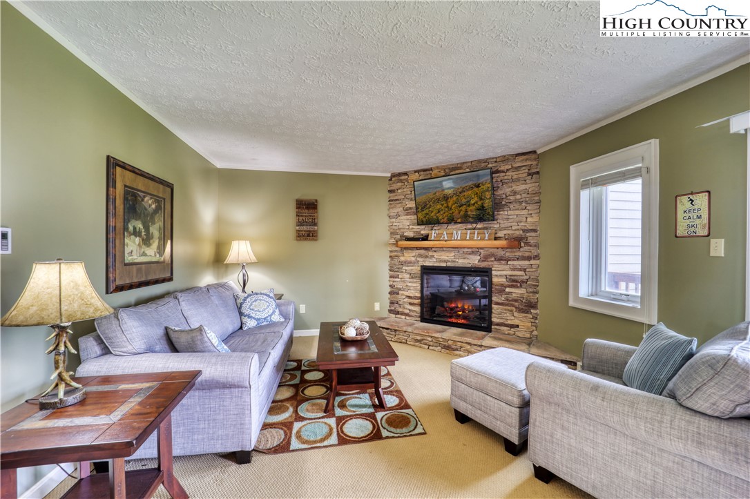 a living room with furniture fireplace and a flat screen tv