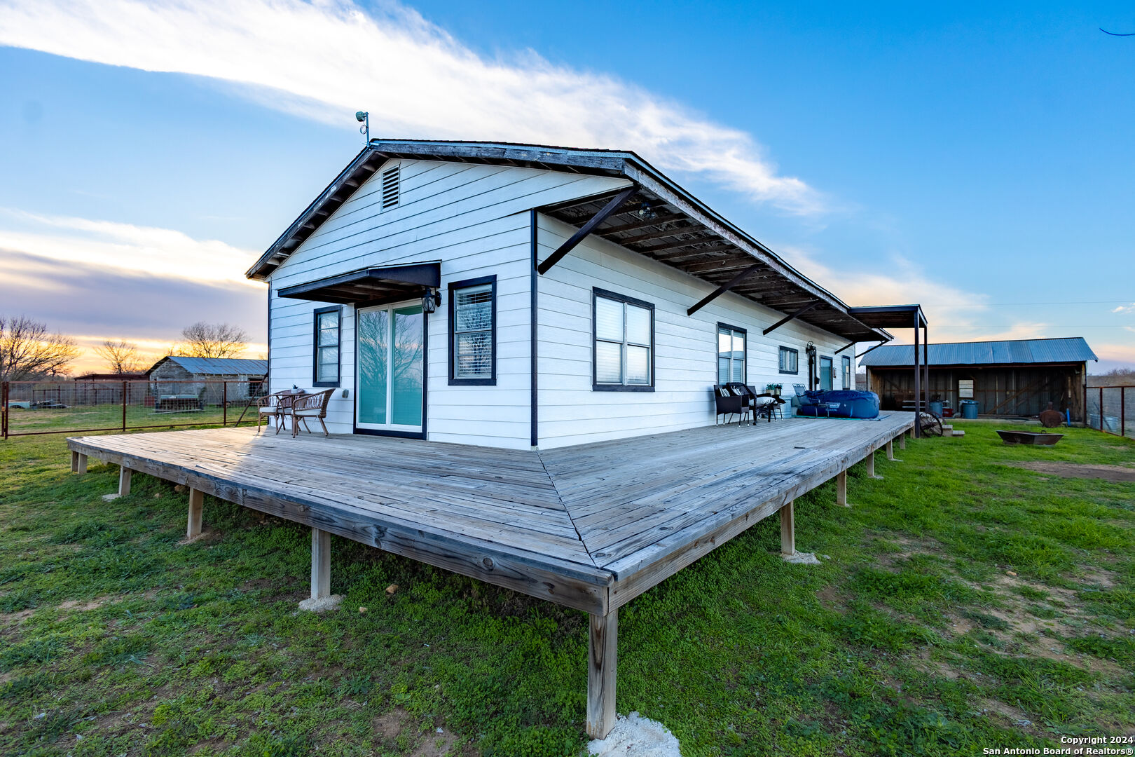 a view of a wooden deck and a yard