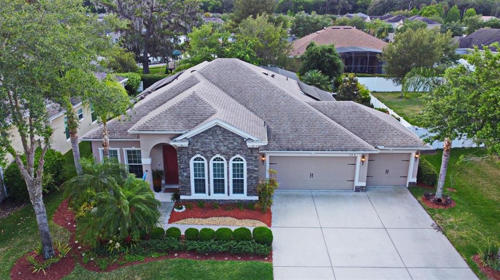 a aerial view of a house with a yard and potted plants