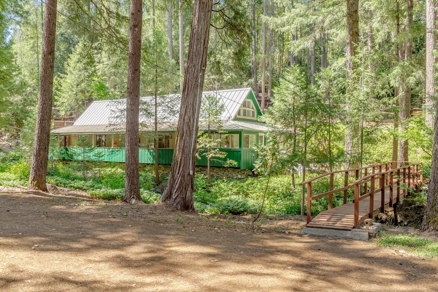 a view of a house with a yard and potted plants