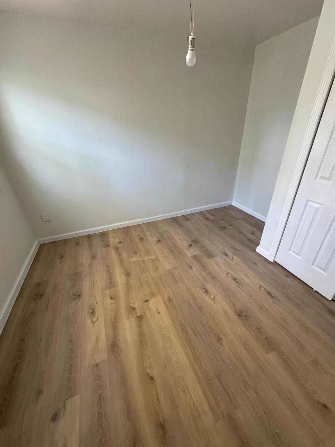 an empty room with wooden floor