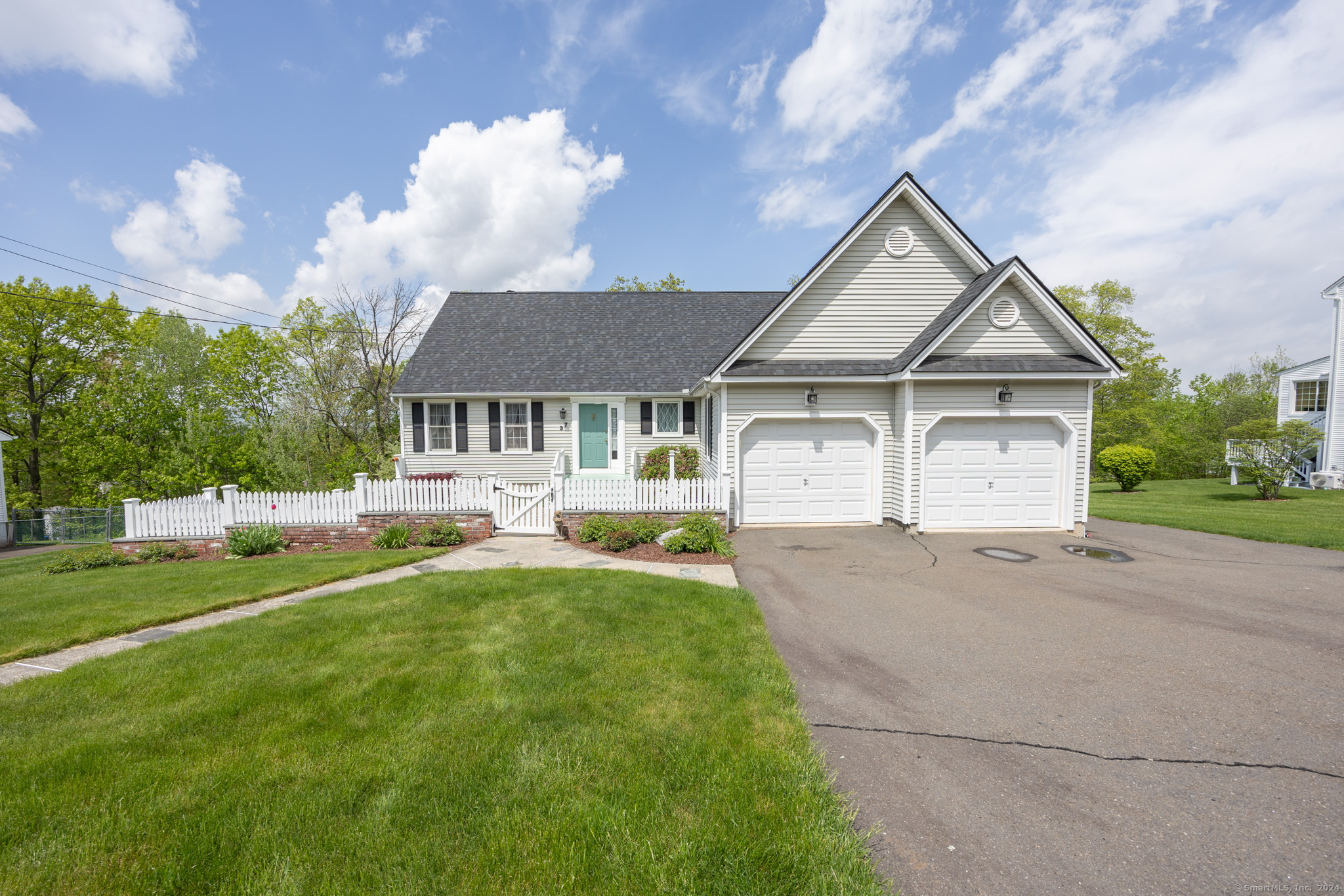 a view of house with yard and outdoor seating