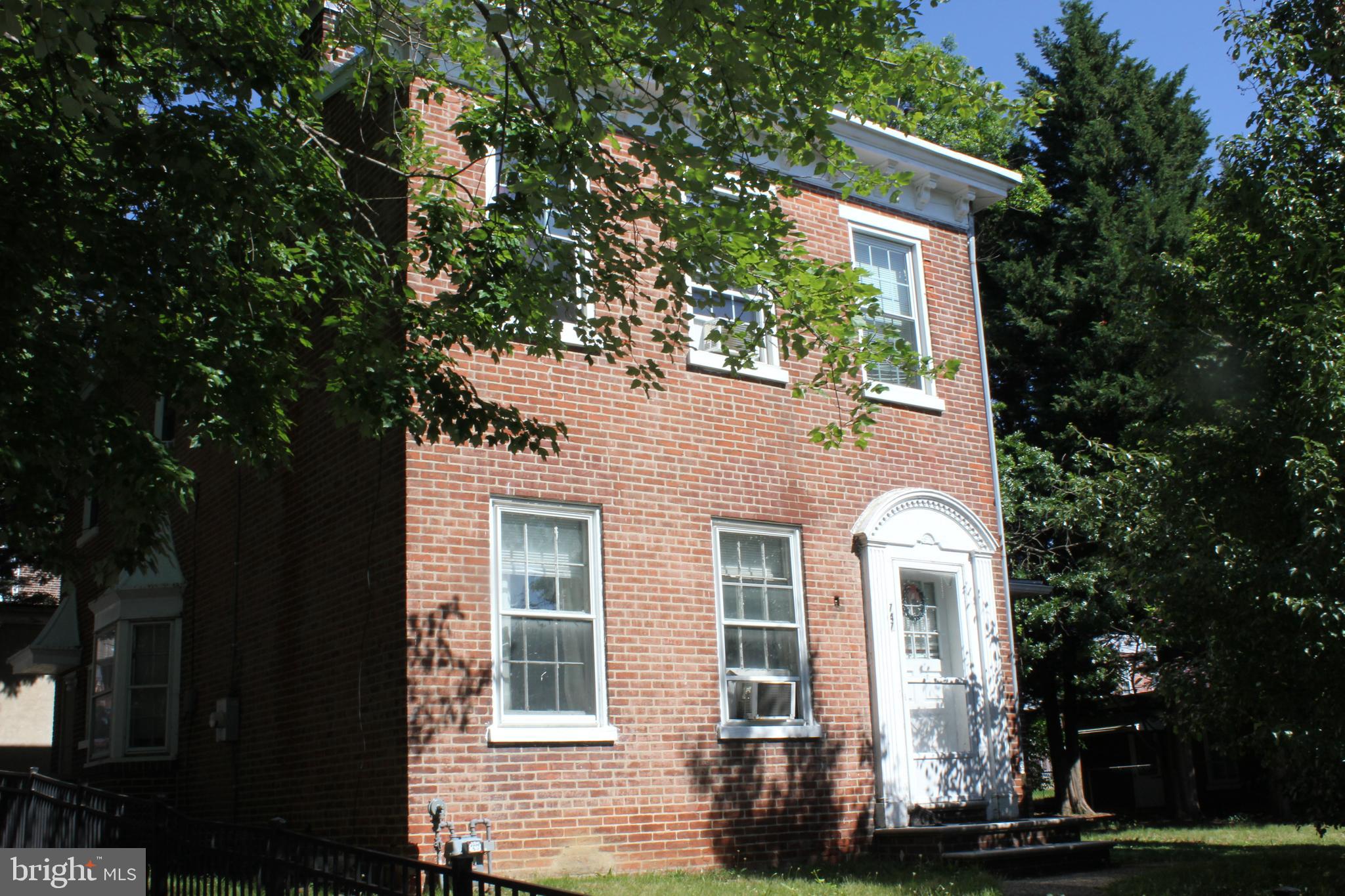 front view of a house with a tree