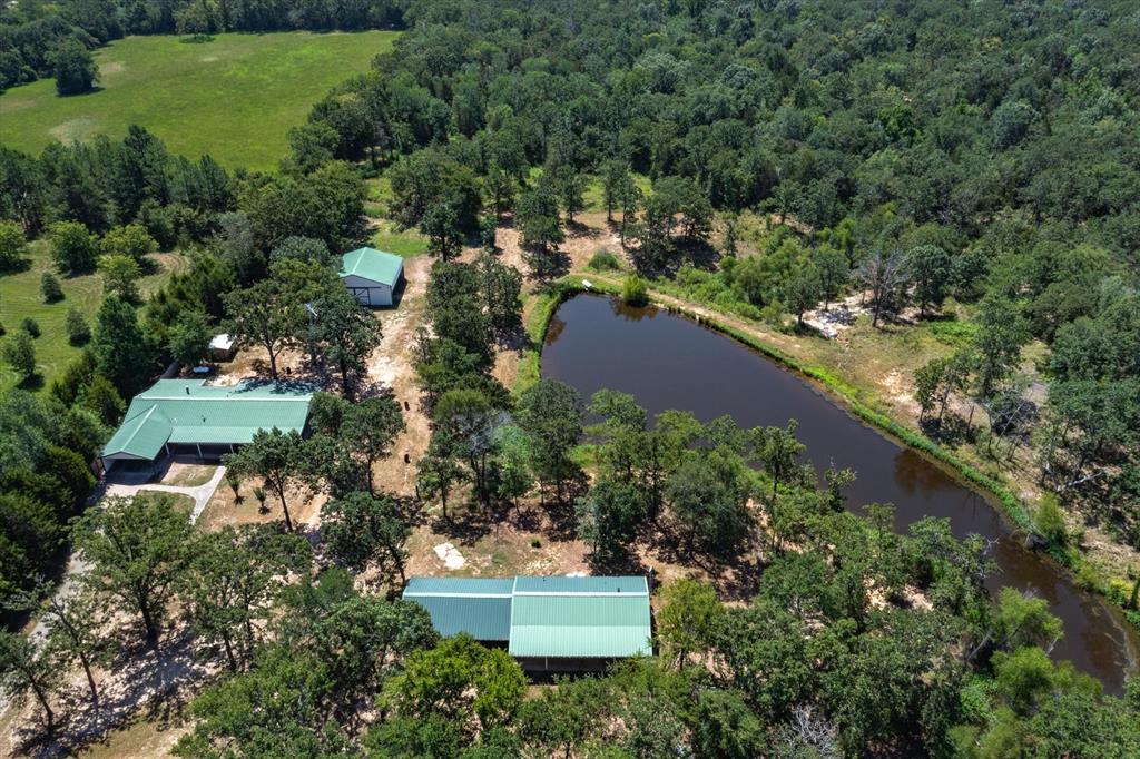 an aerial view of a house with a yard and lake view