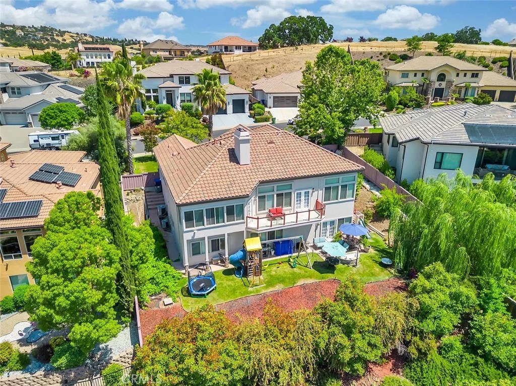 an aerial view of multiple houses with a yard