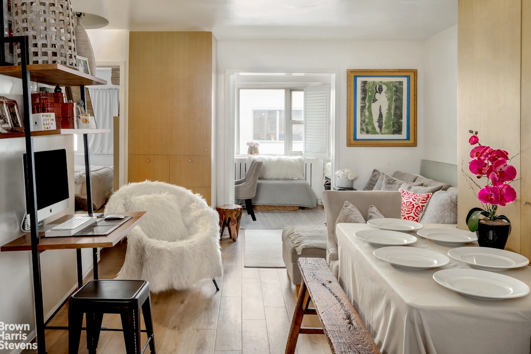 a living room with furniture and a floor to ceiling window