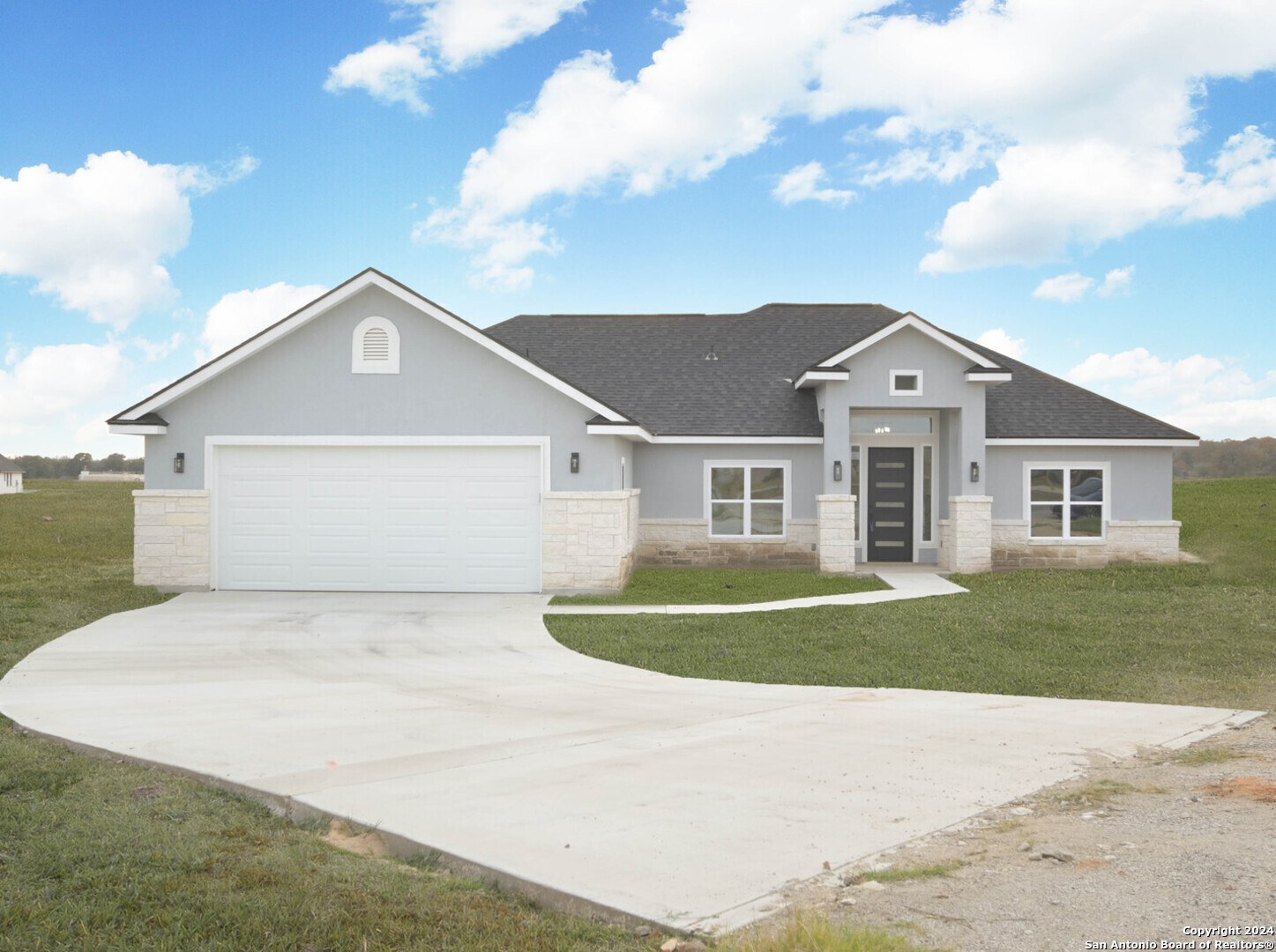 a front view of a house with a yard