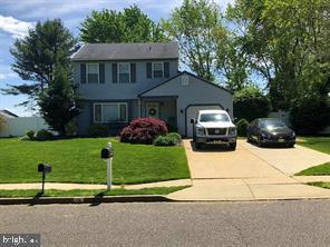 a front view of a house with a garden and plants