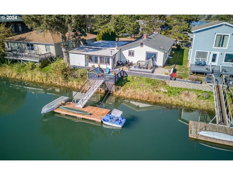 a aerial view of a house with a garden and lake view