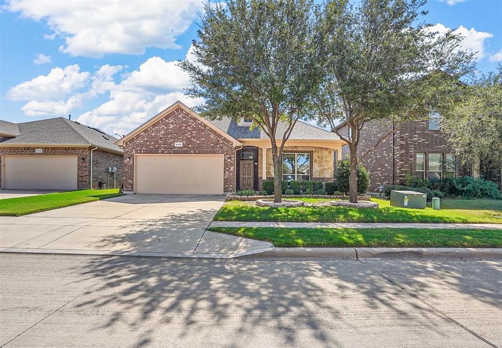 a front view of a house with a yard and a garage