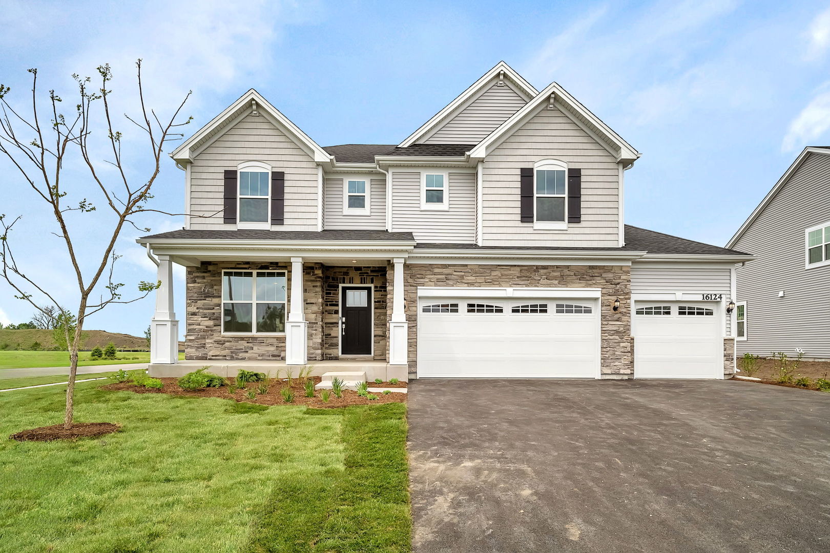 a front view of a house with a yard and garage