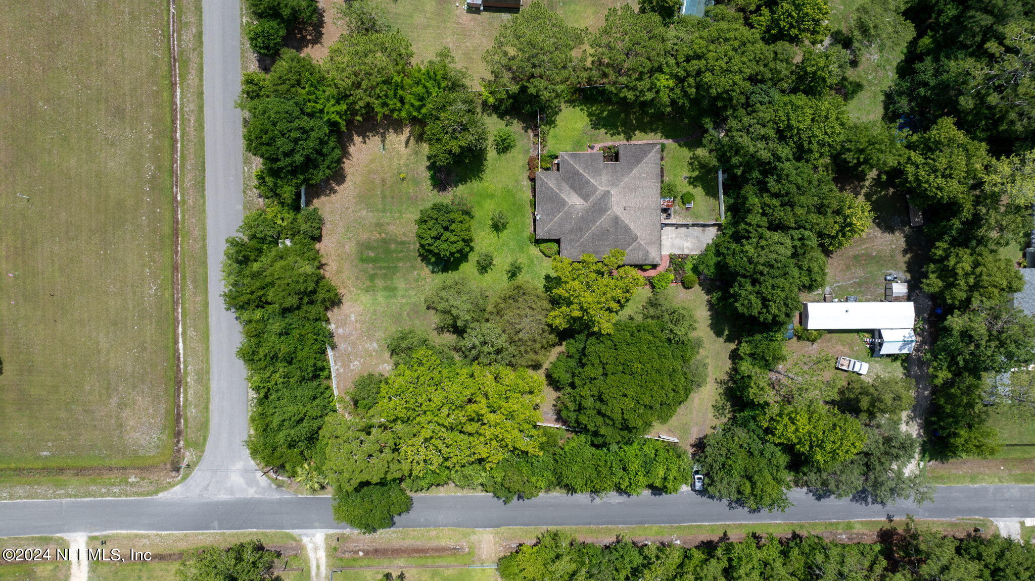 an aerial view of a house with a yard and garden