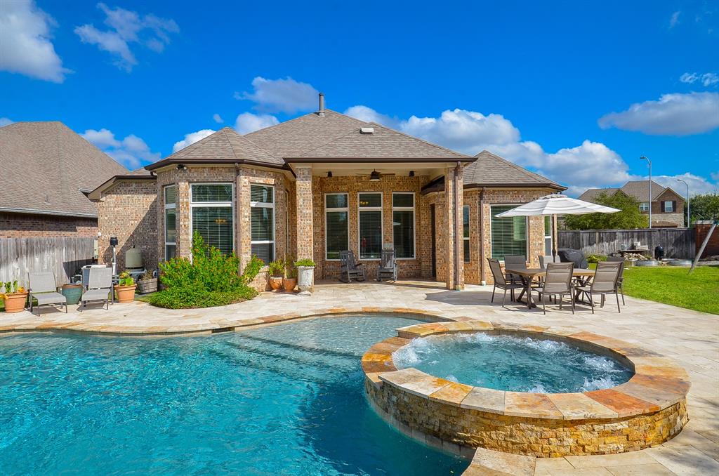 a view of a house with backyard porch and sitting area