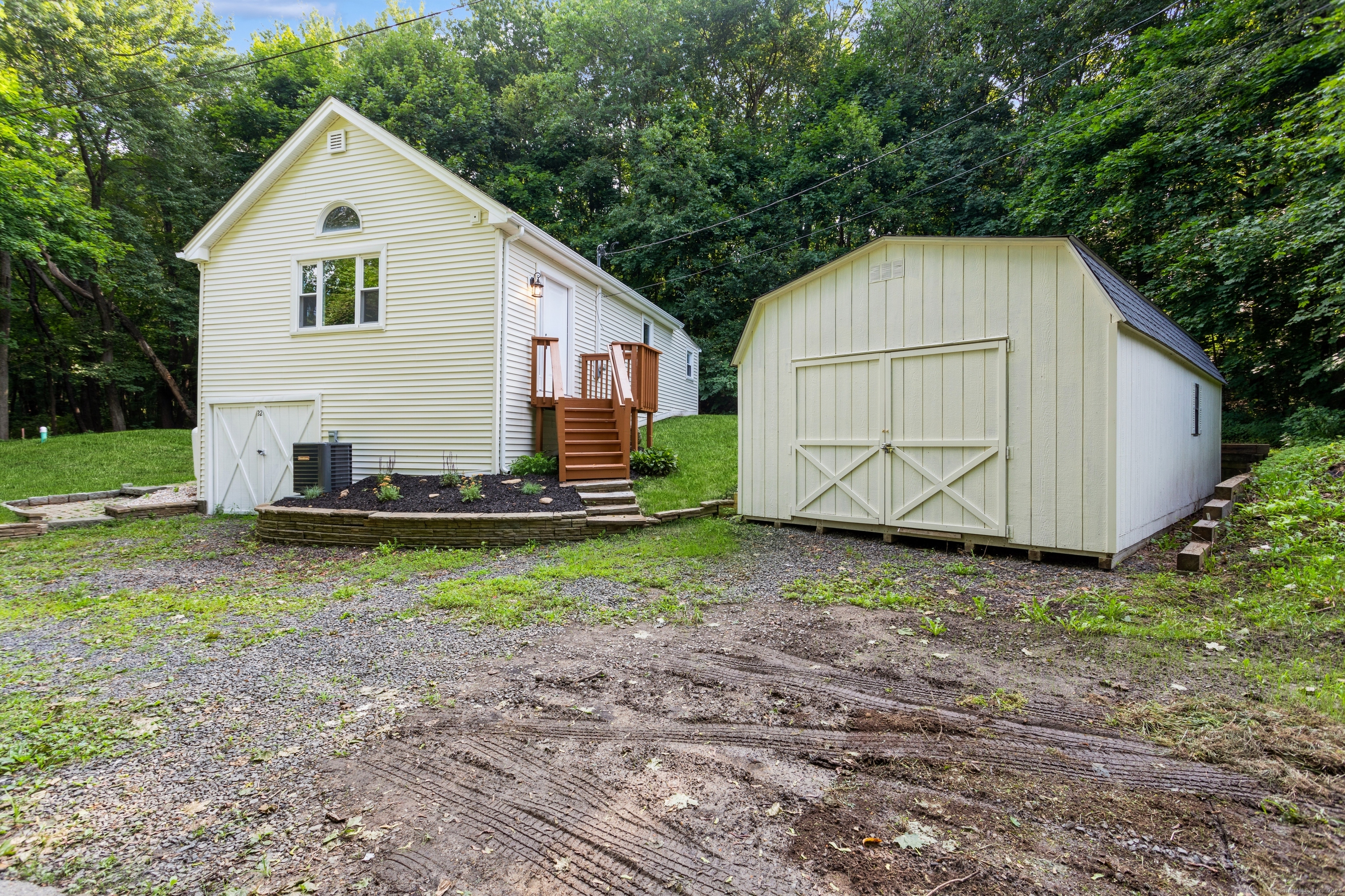 a view of backyard of house with wooden fence