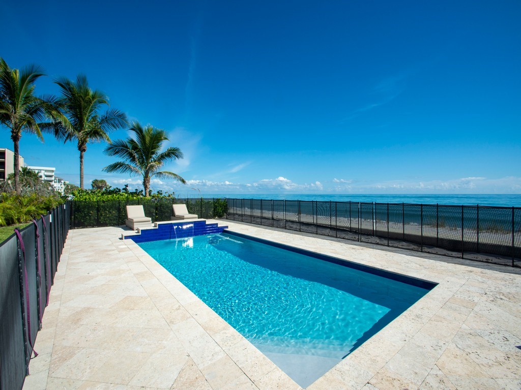 a view of swimming pool with outdoor seating and plants