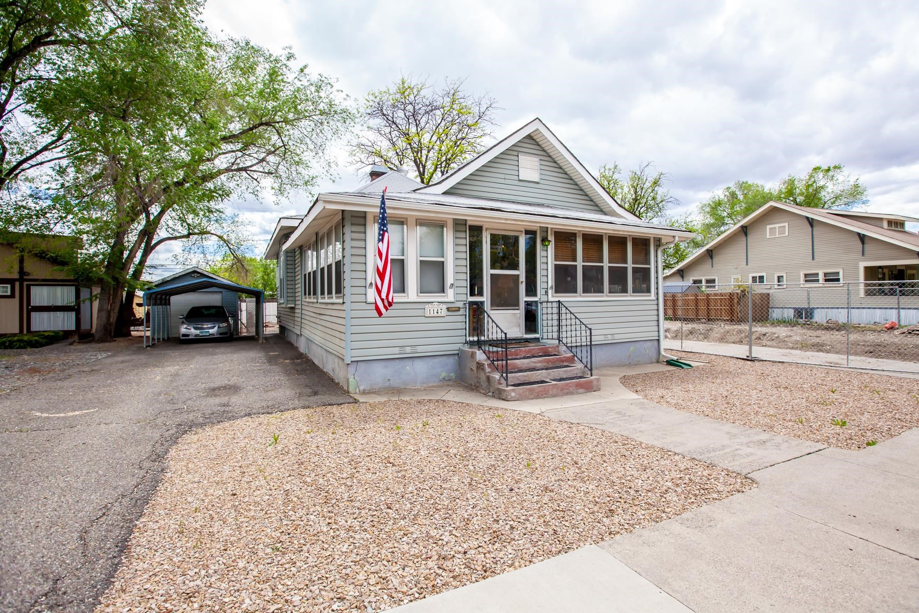 a front view of a house with a yard patio and garage