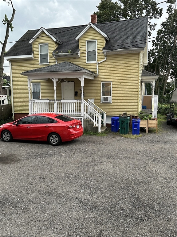 a front view of a house with cars