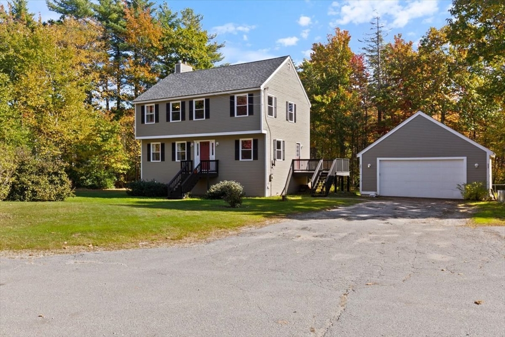 a front view of house with yard and green space