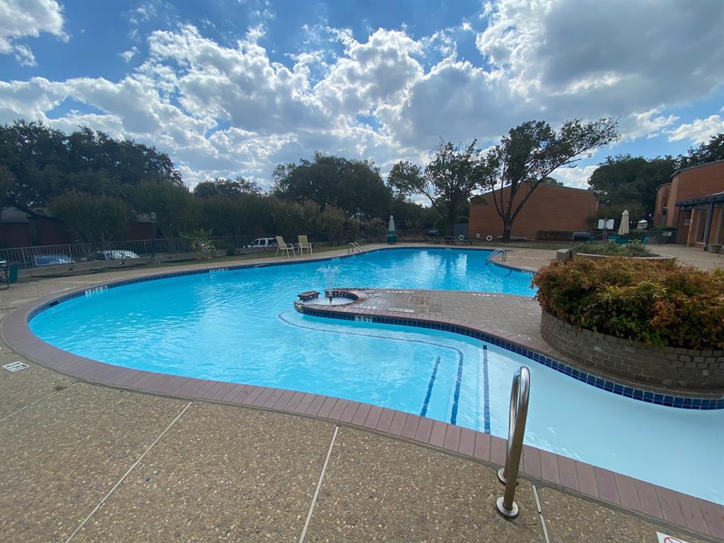 a view of a swimming pool with a yard