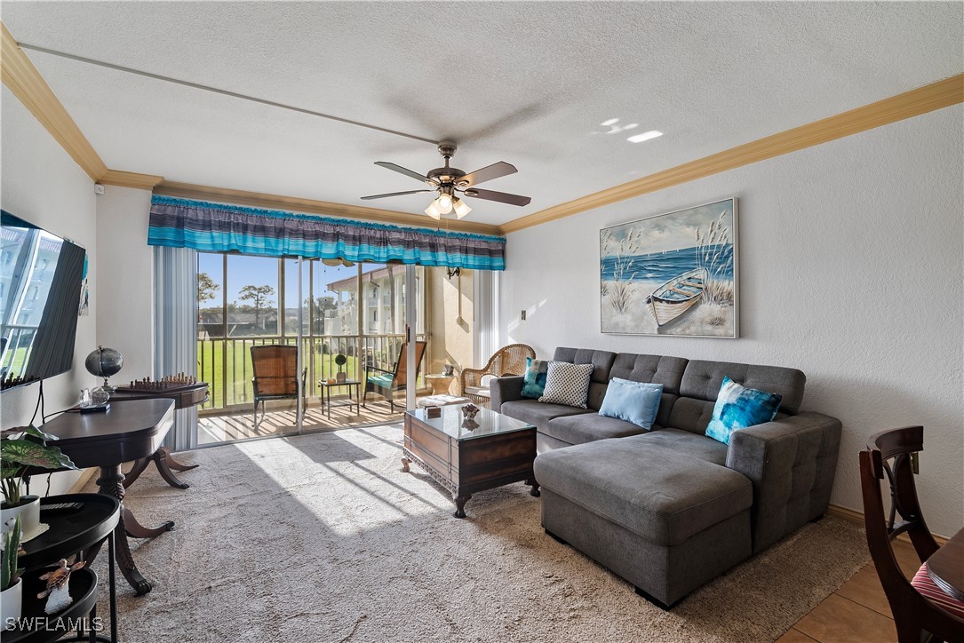 a living room with furniture and large windows