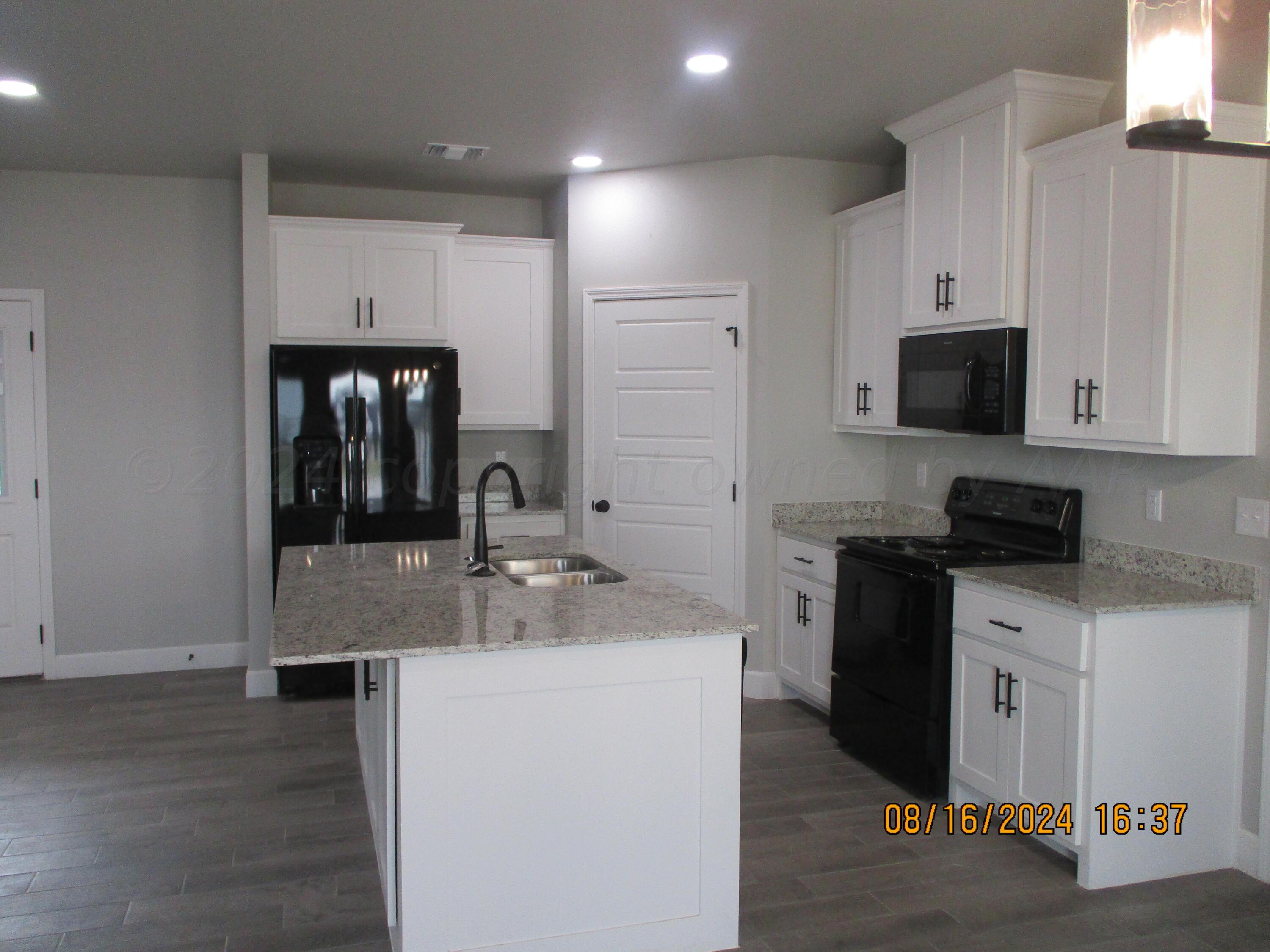 a kitchen with a sink and a refrigerator