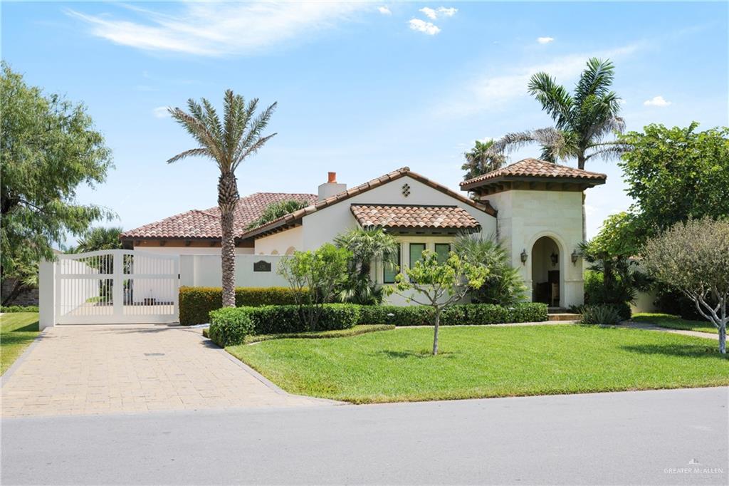 a front view of a house with a yard and potted plants