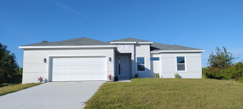 a front view of a house with a yard and garage