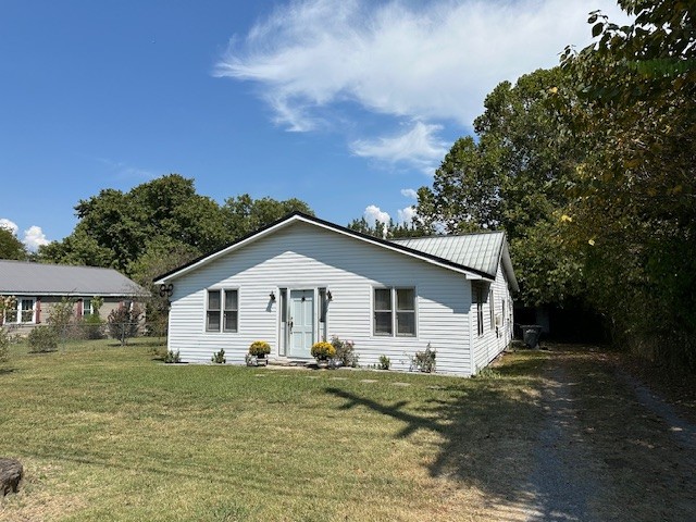 a view of a white house with a yard