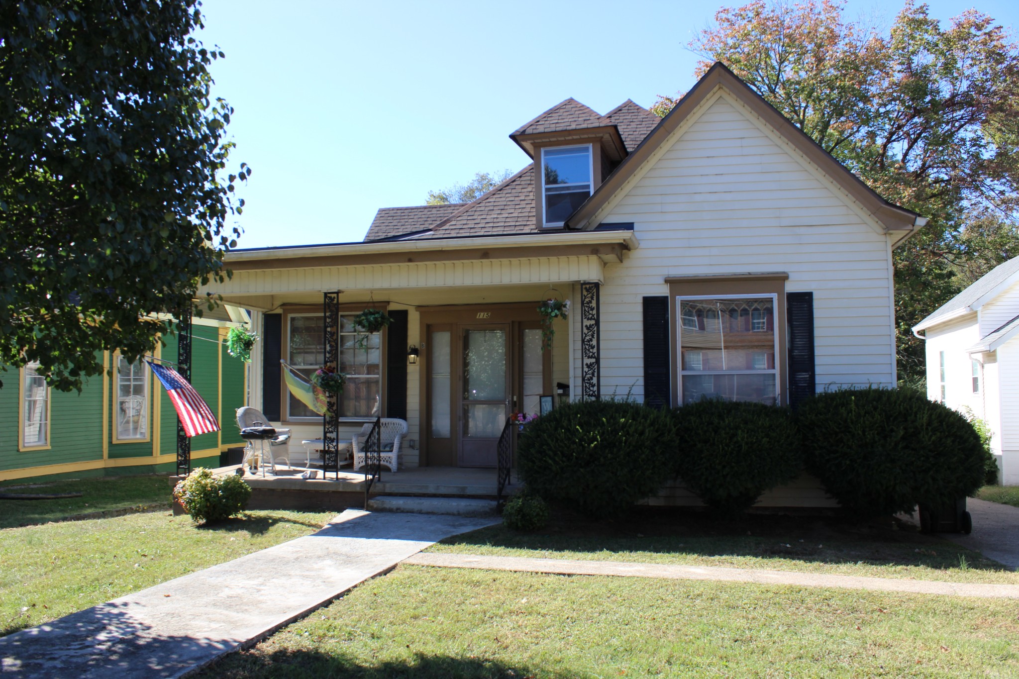 a view of a house with a patio and a yard