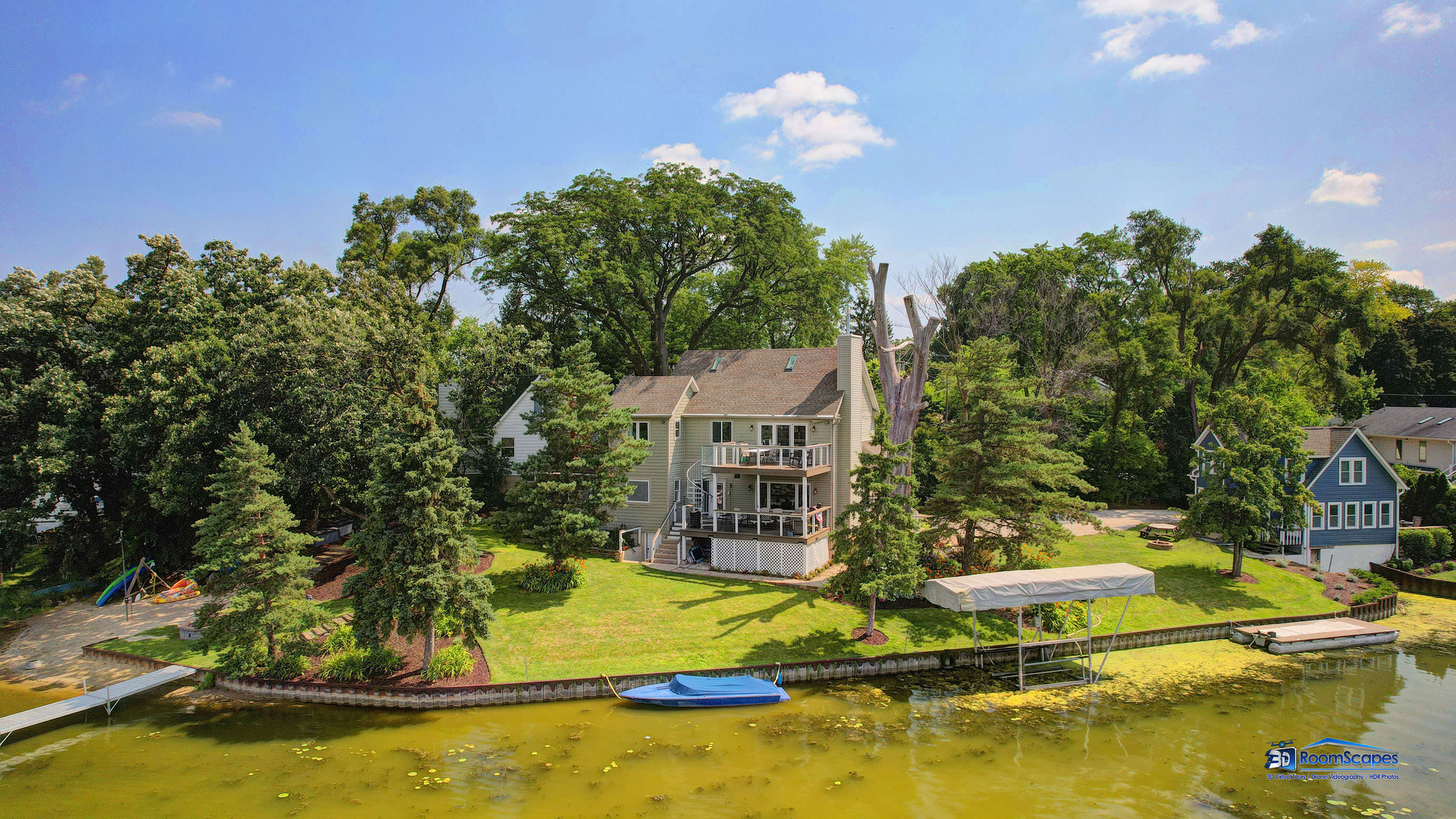 a view of an house with swimming pool and trees in the background