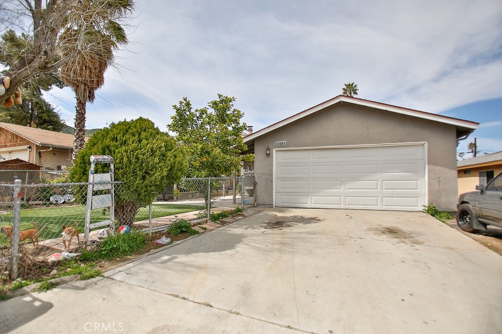 a view of a house with a yard and garage