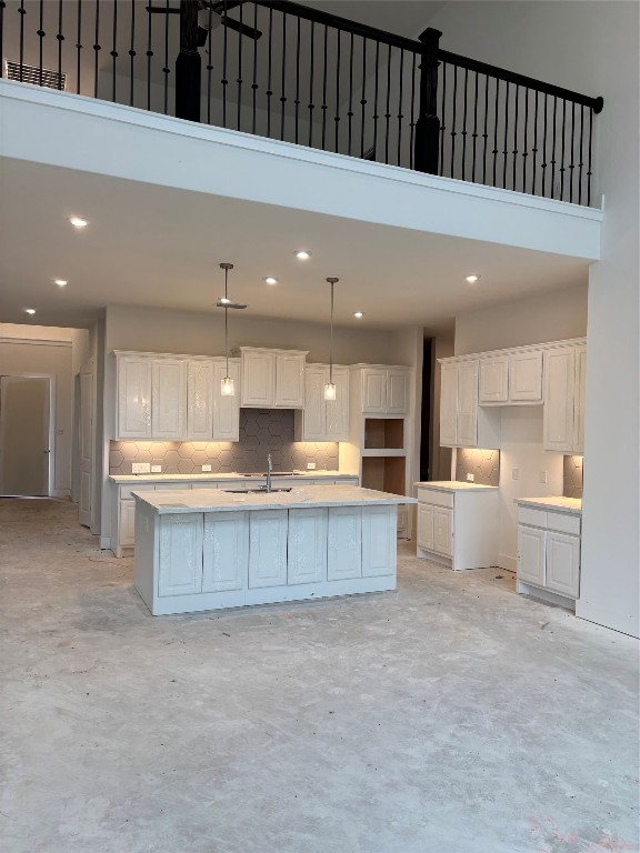 a kitchen with stainless steel appliances kitchen island granite countertop a stove a sink and a refrigerator