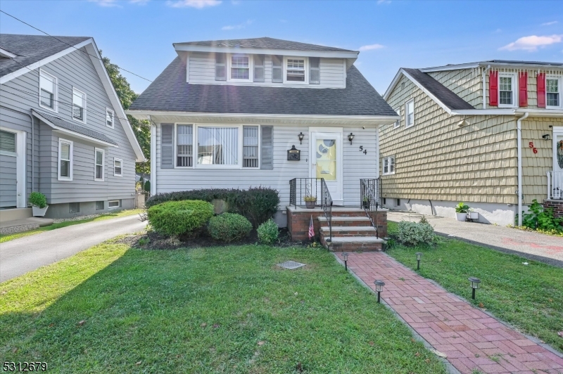 a front view of a house with a garden and yard