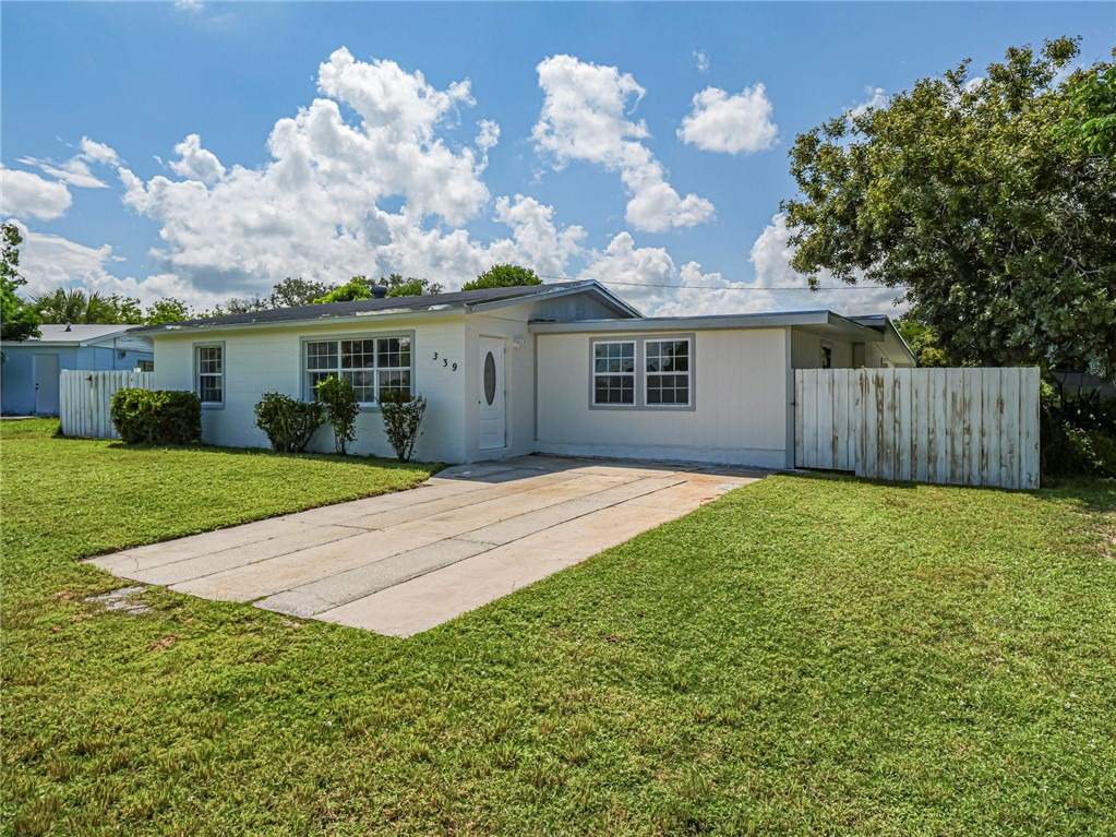 a view of house with yard and green space