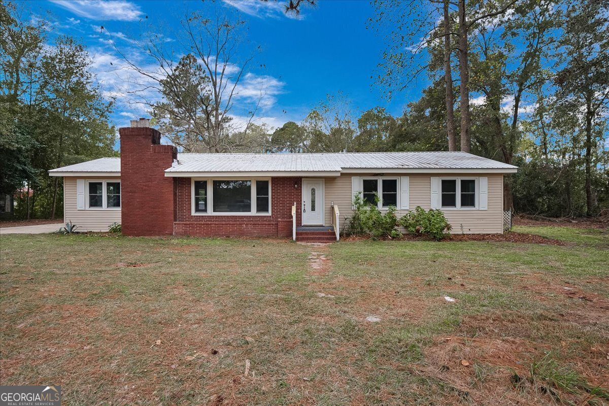 a front view of a house with a garden