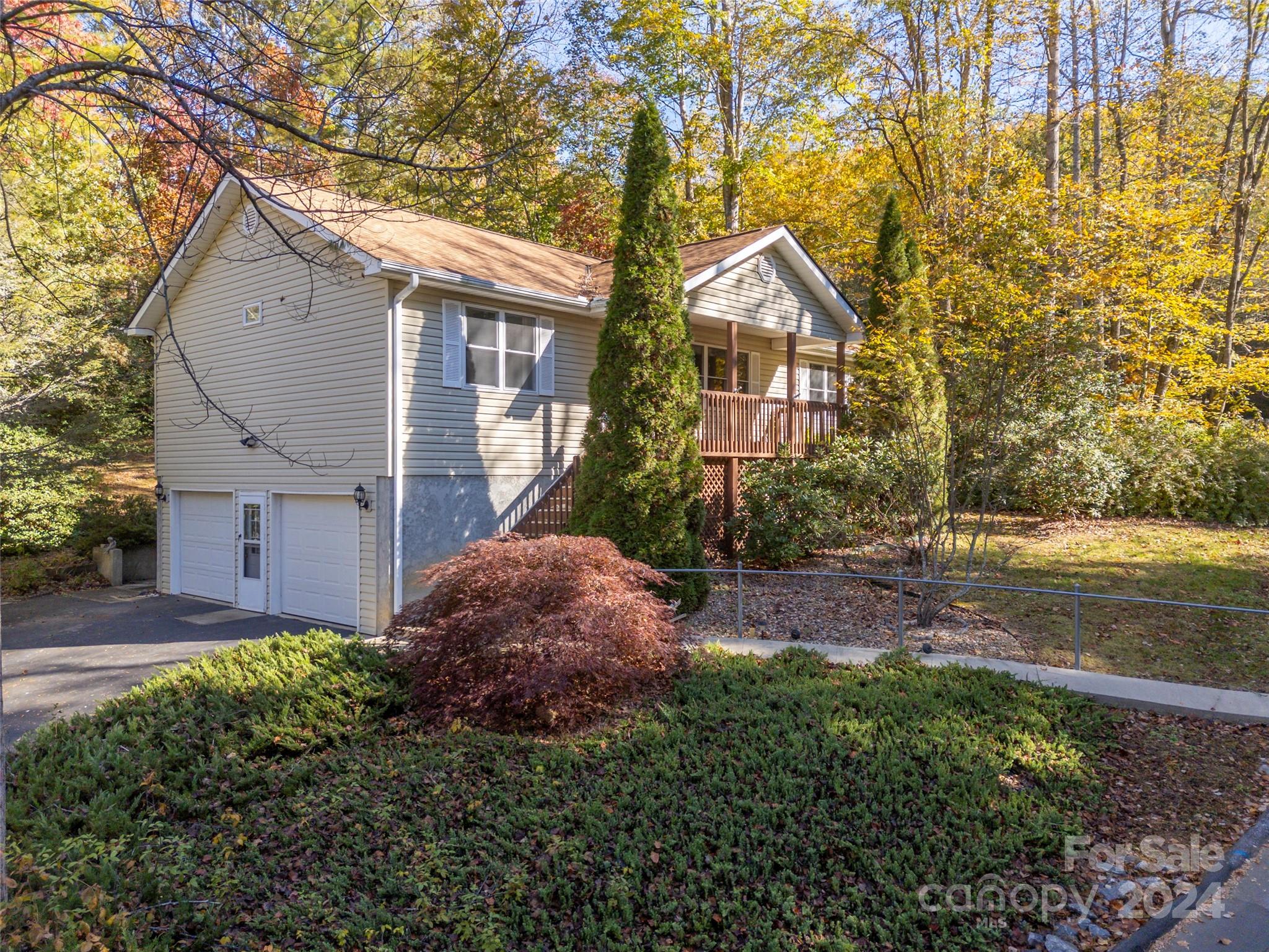 a view of a house with a yard and tree s