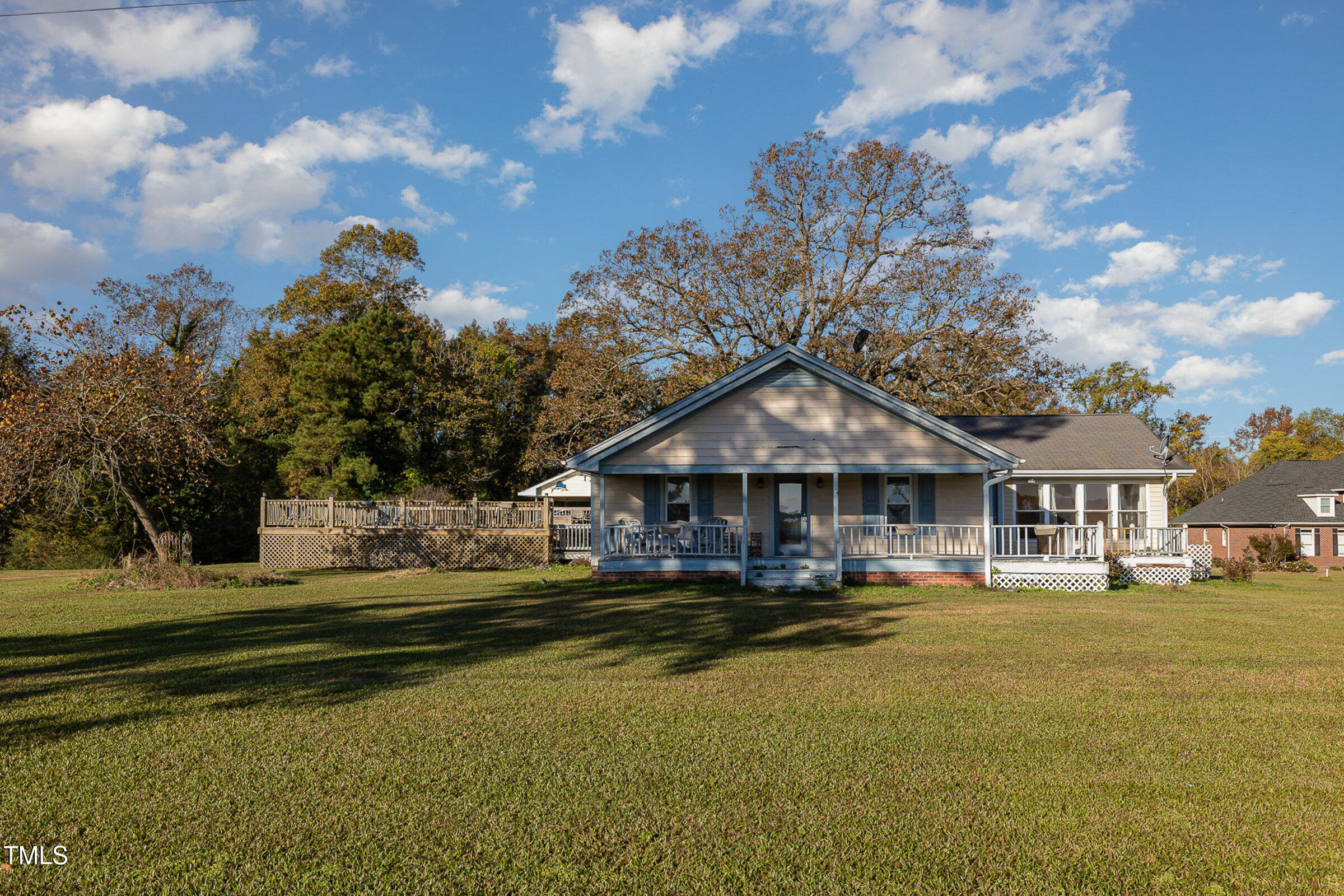 a front view of a house with swimming pool and porch