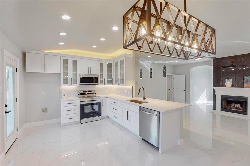 a kitchen with stainless steel appliances granite countertop a sink and cabinets