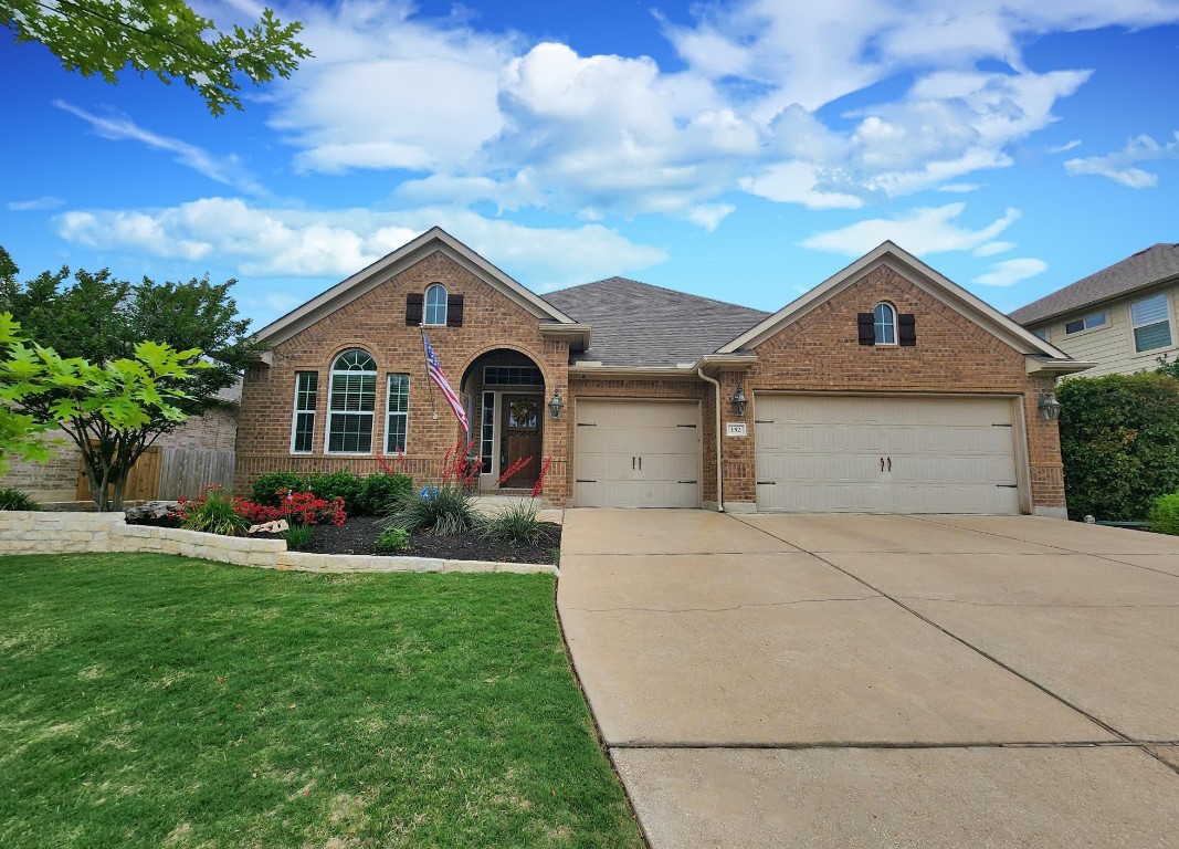 a front view of a house with a yard and garage