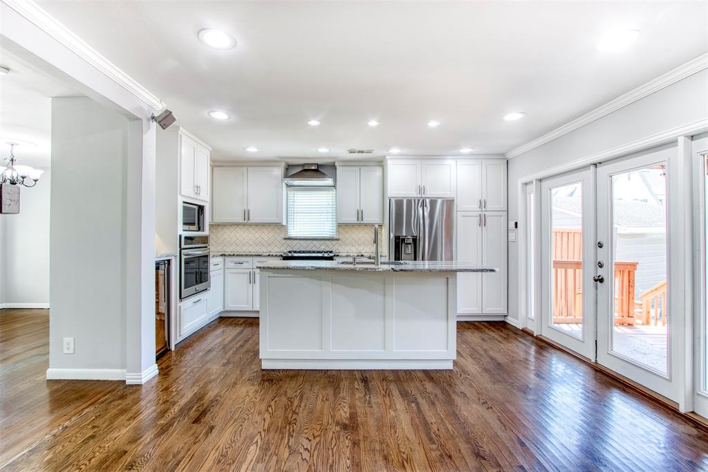 a kitchen with stainless steel appliances refrigerator sink and cabinets