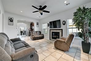 a living room with furniture a flat screen tv and a fireplace