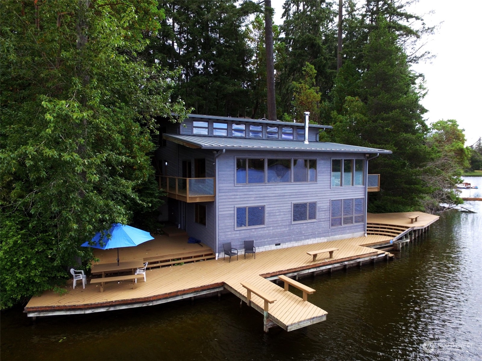 an aerial view of a house with swimming pool and patio