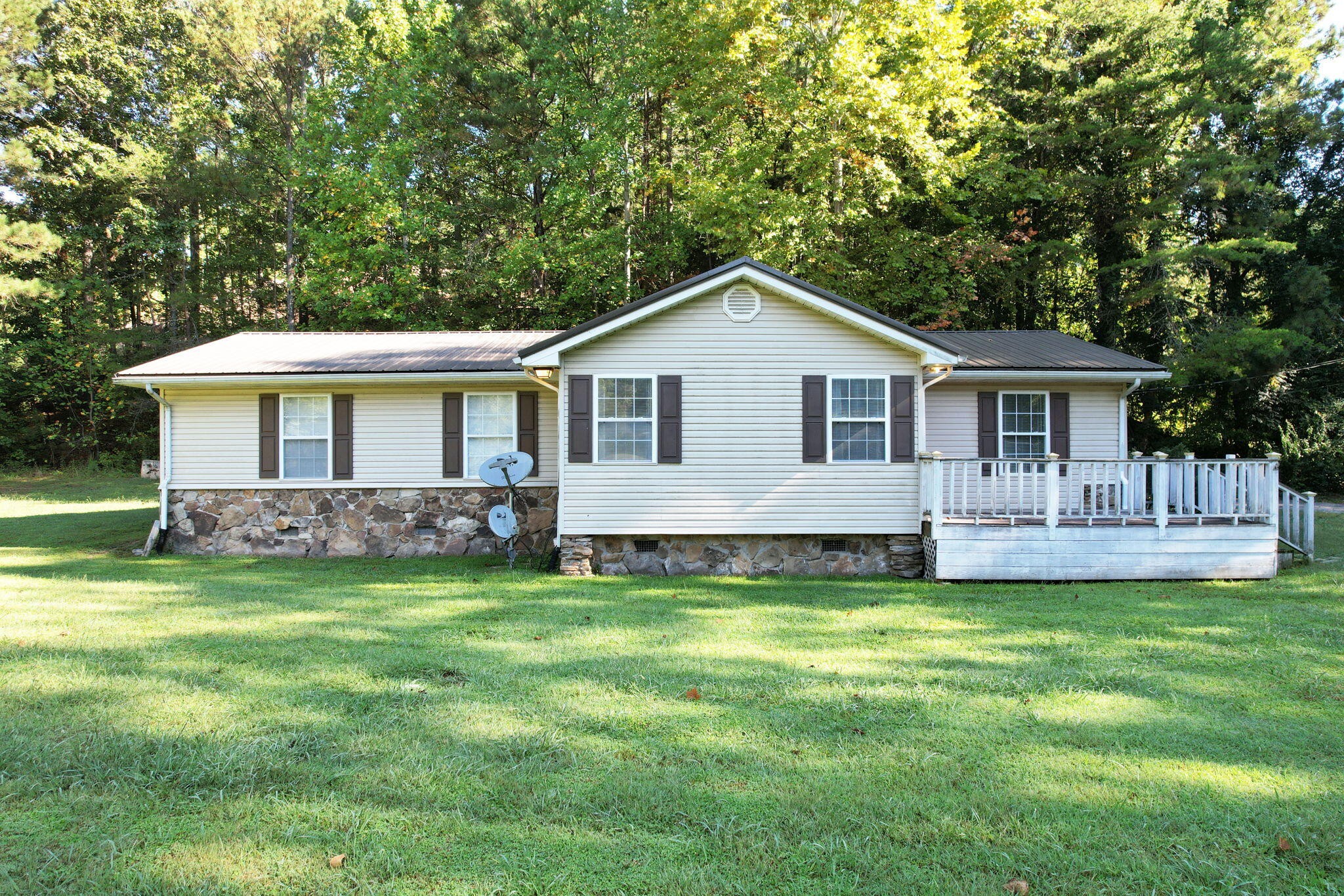 a front view of a house with a garden and yard