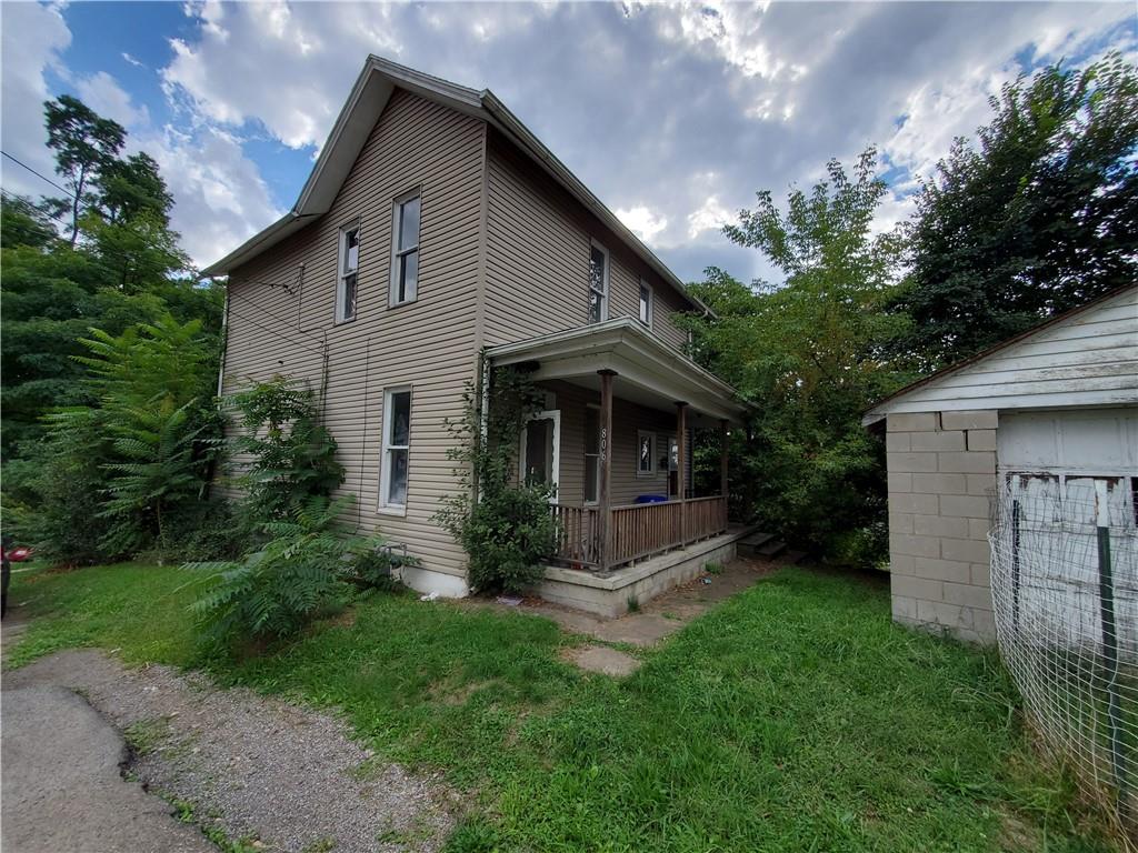 a front view of house with a garden