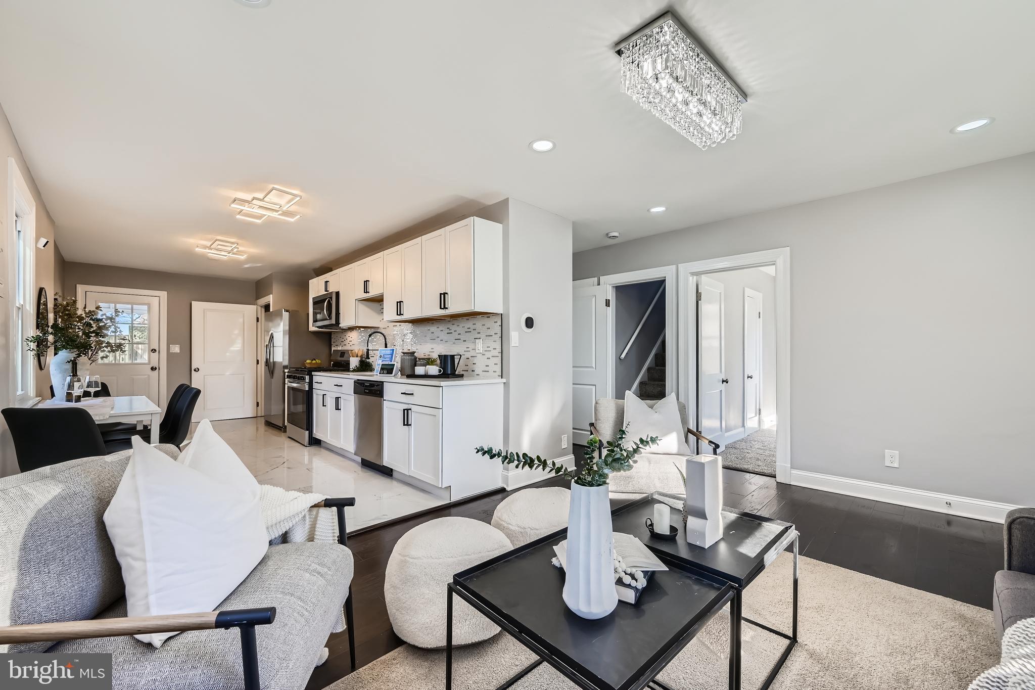 a living room with lots of furniture and kitchen view