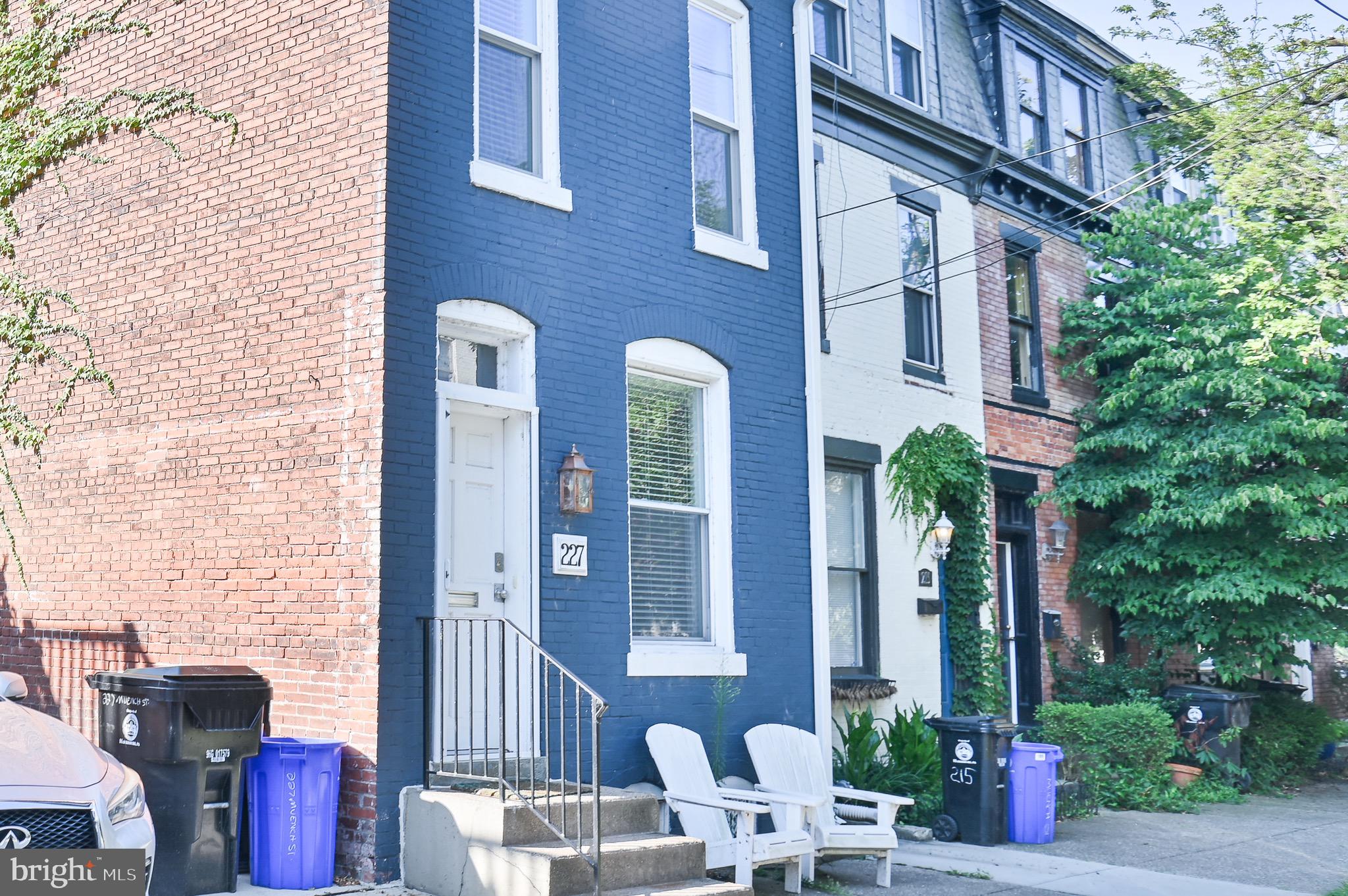 a couple of table and chairs in front of brick building