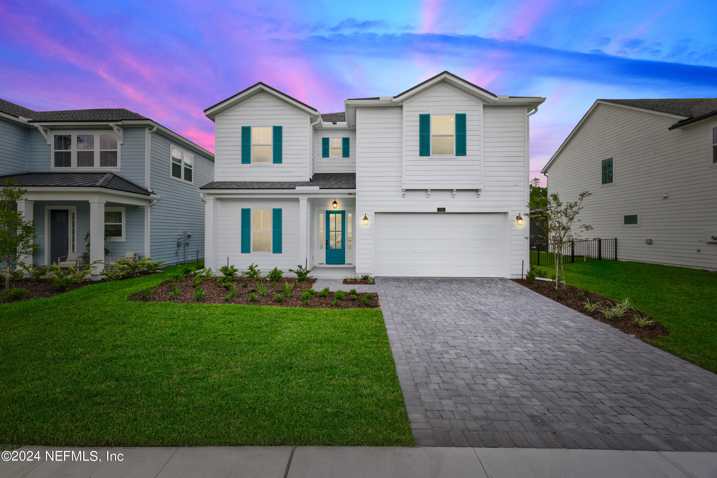 a front view of house with yard and green space