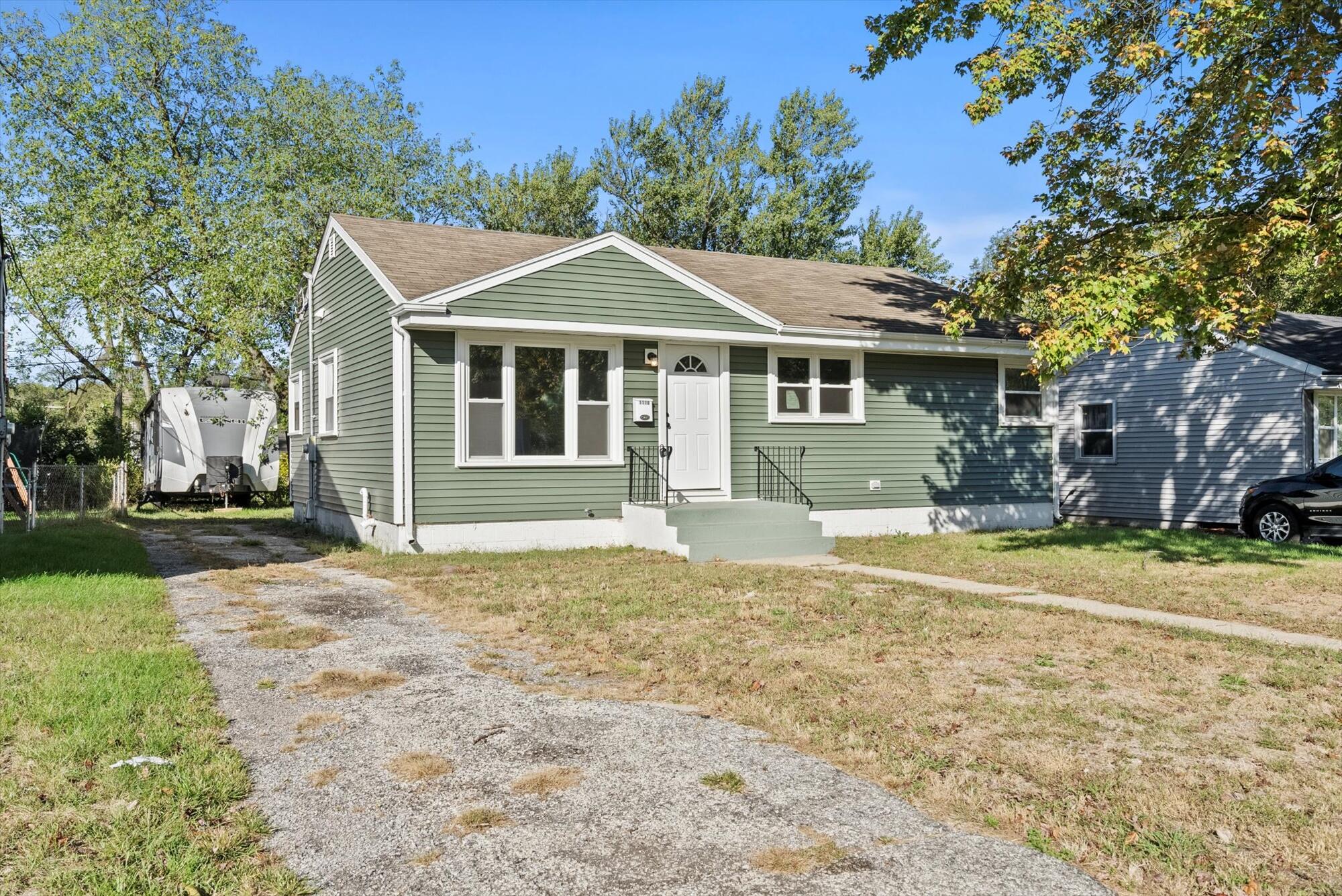 a front view of a house with a garden