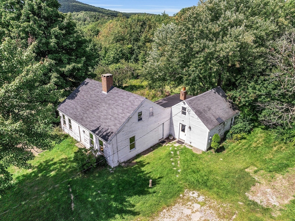 an aerial view of a house with yard and outdoor seating